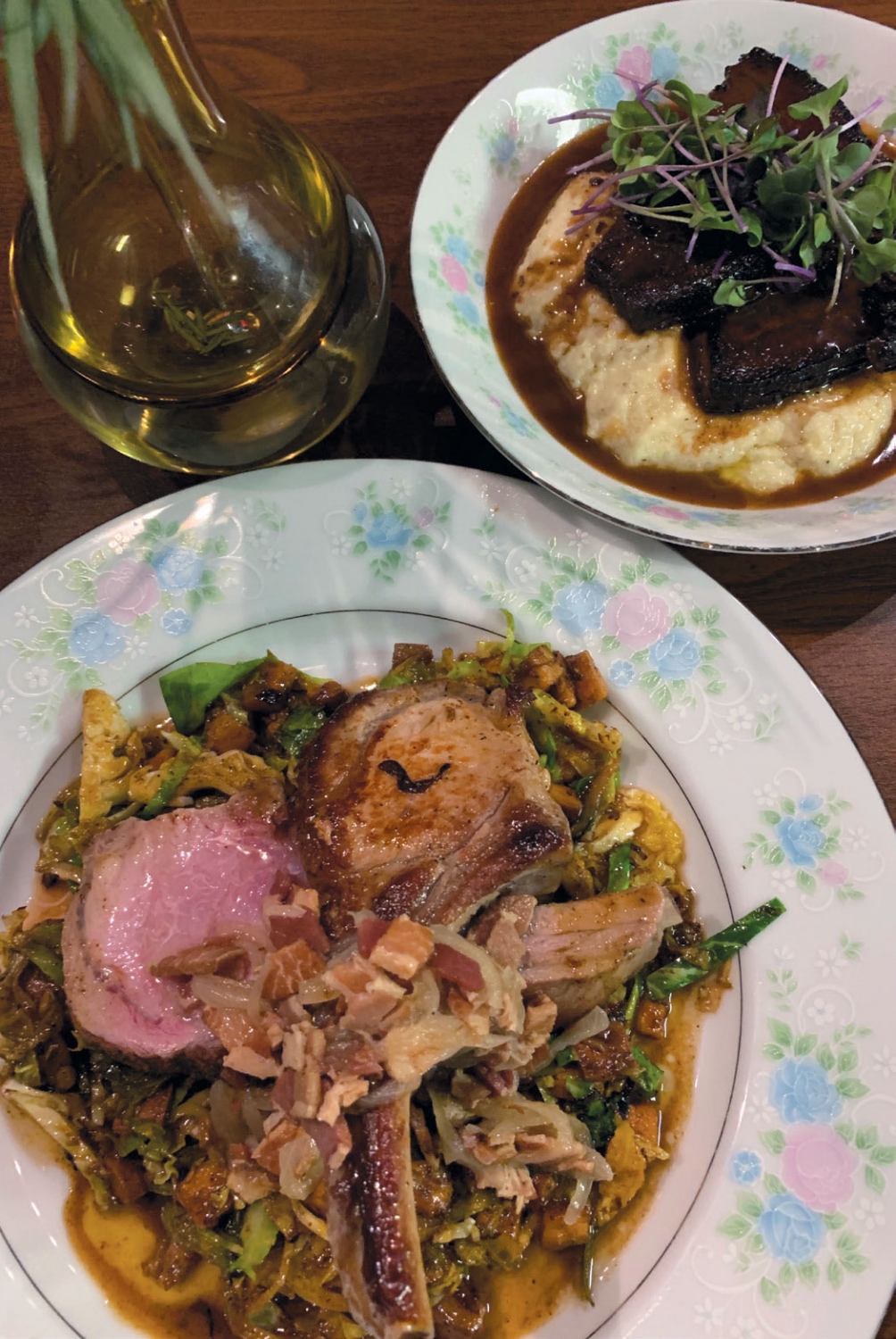 Pasture raised pork loin chops on brussels sprout ragout and braised short ribs on creamy polenta.